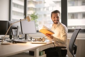 adult male working online at desk